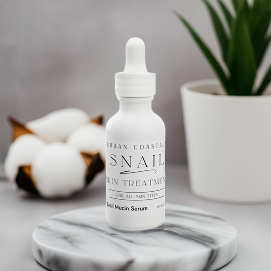 1oz snail facial serum in a white glass bottle